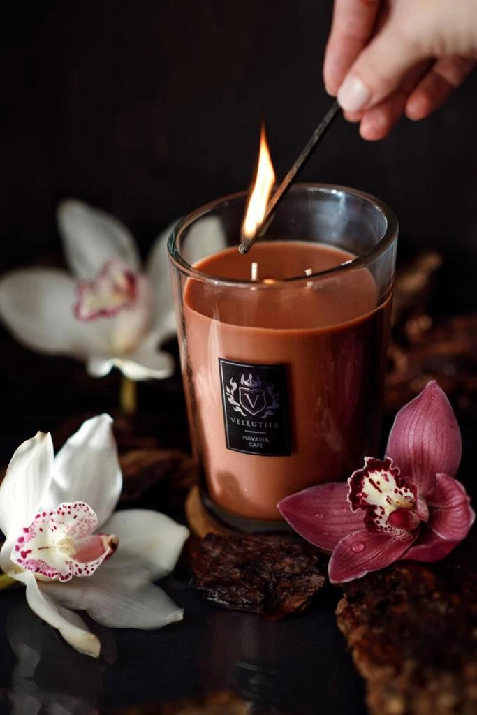 Lighting a VELLUTIER Havana Cafe candle in a floral setting